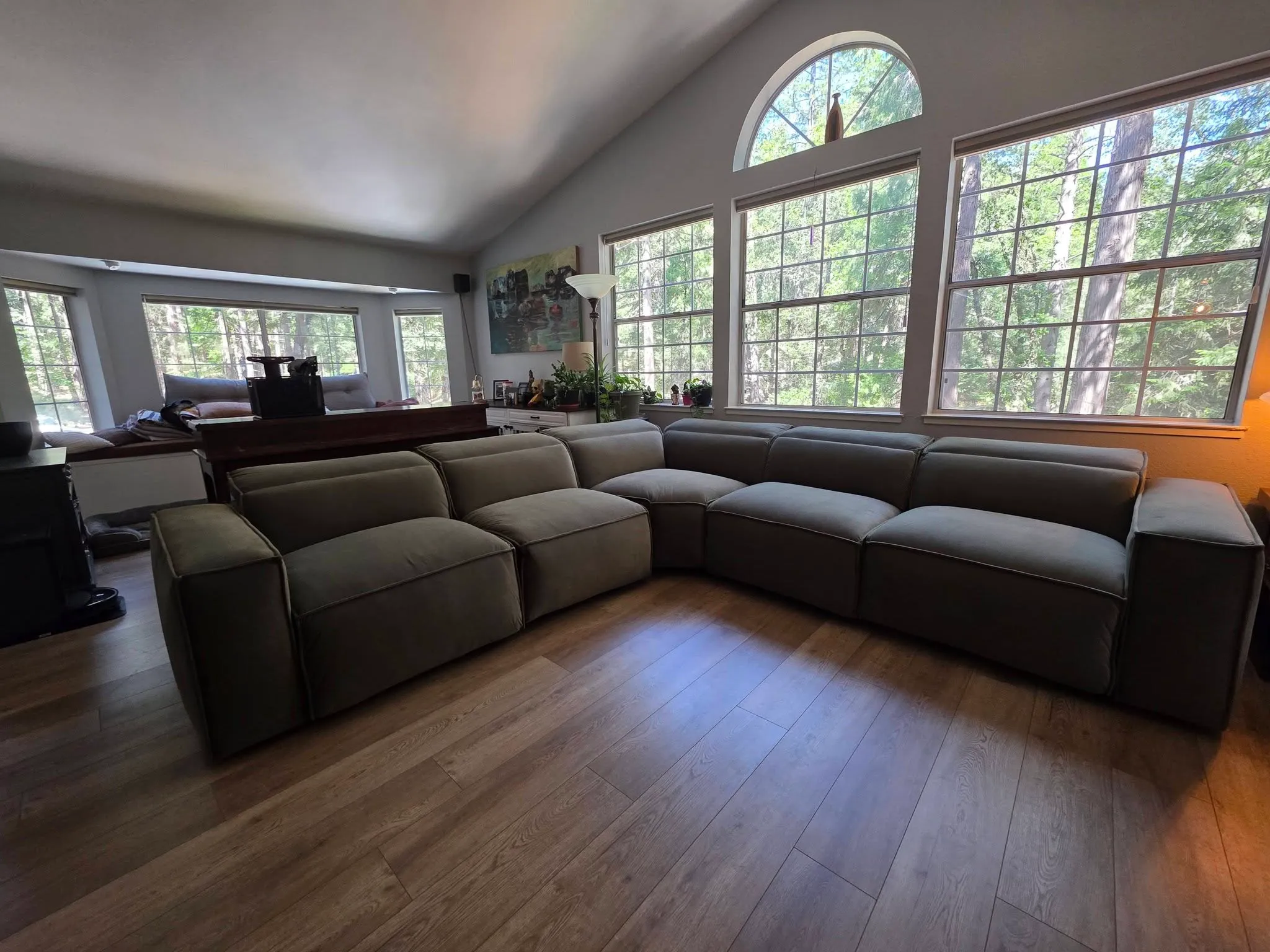 A modular sectional set up in a bright Nevada County home with forest-view windows