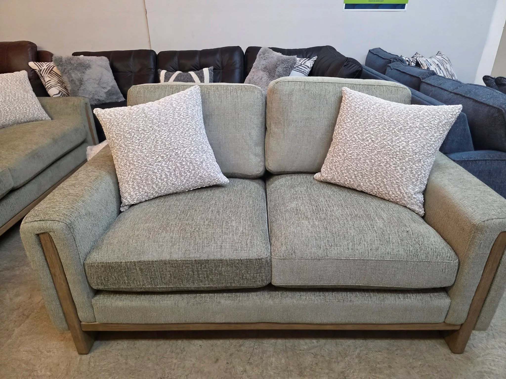 A teal fabric sofa on tapered wood legs at BoxDrop Grass Valley