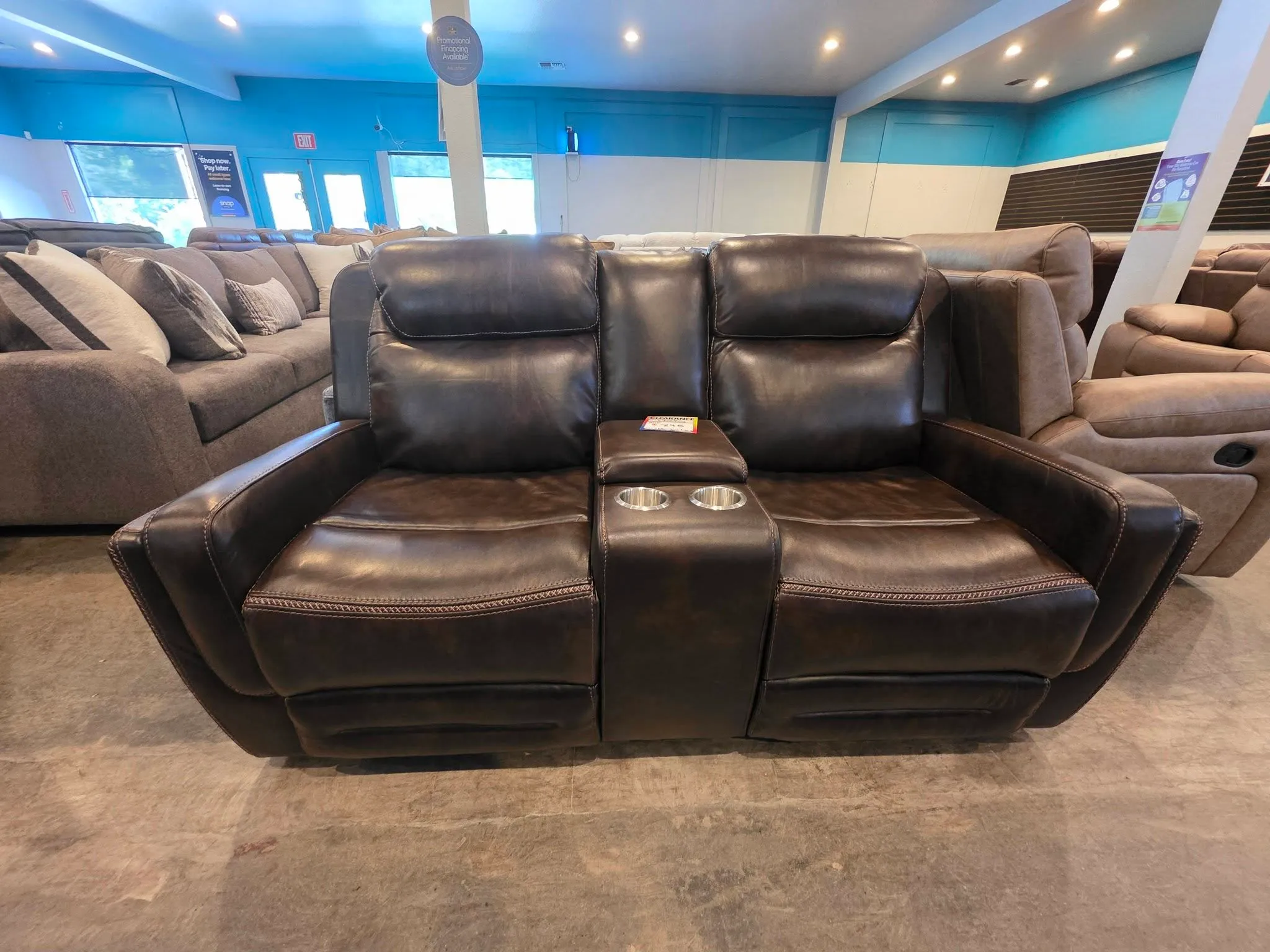 A dark leather power-reclining loveseat at the BoxDrop Grass Valley store